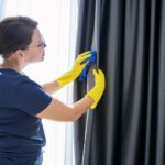 woman cleaning curtains
