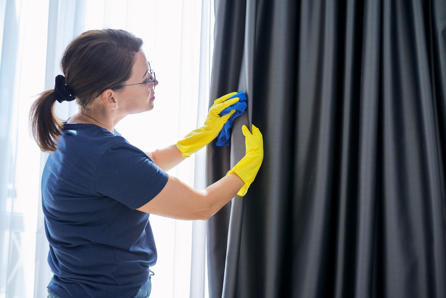 woman cleaning curtains